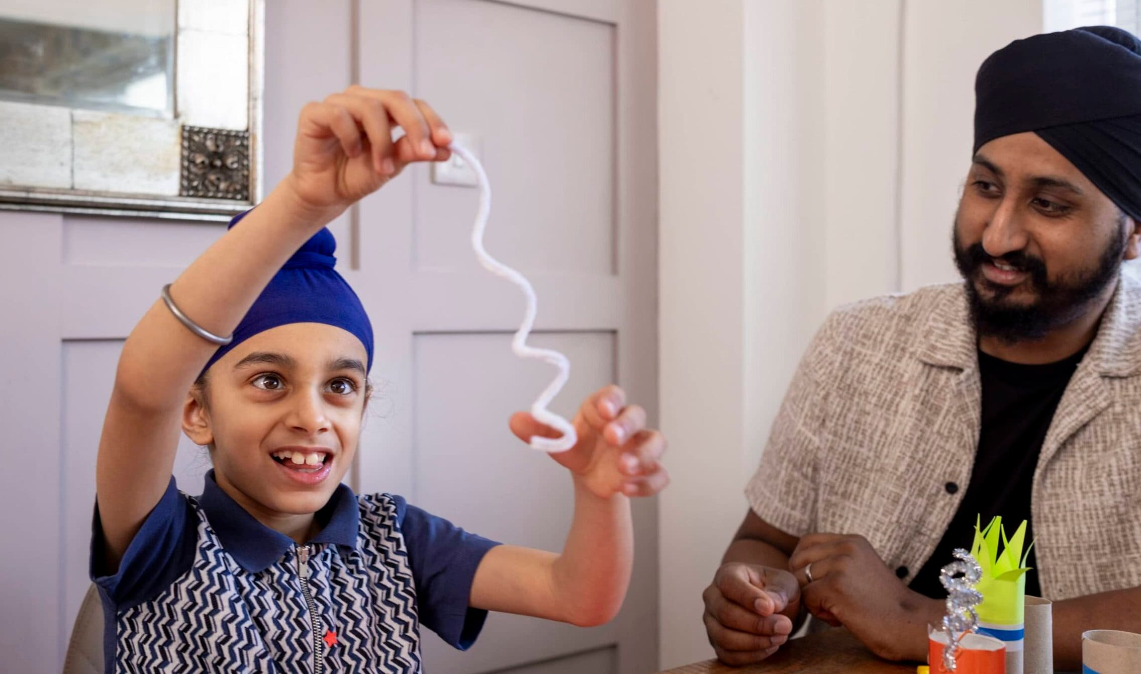 boy and dad playing with pipe cleaners