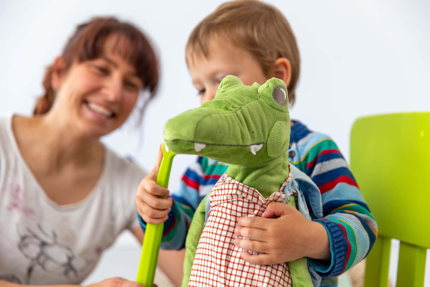 toddler playing with a dinosaur